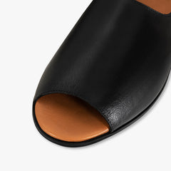 Black open-toe sandal with brown insole on a white background