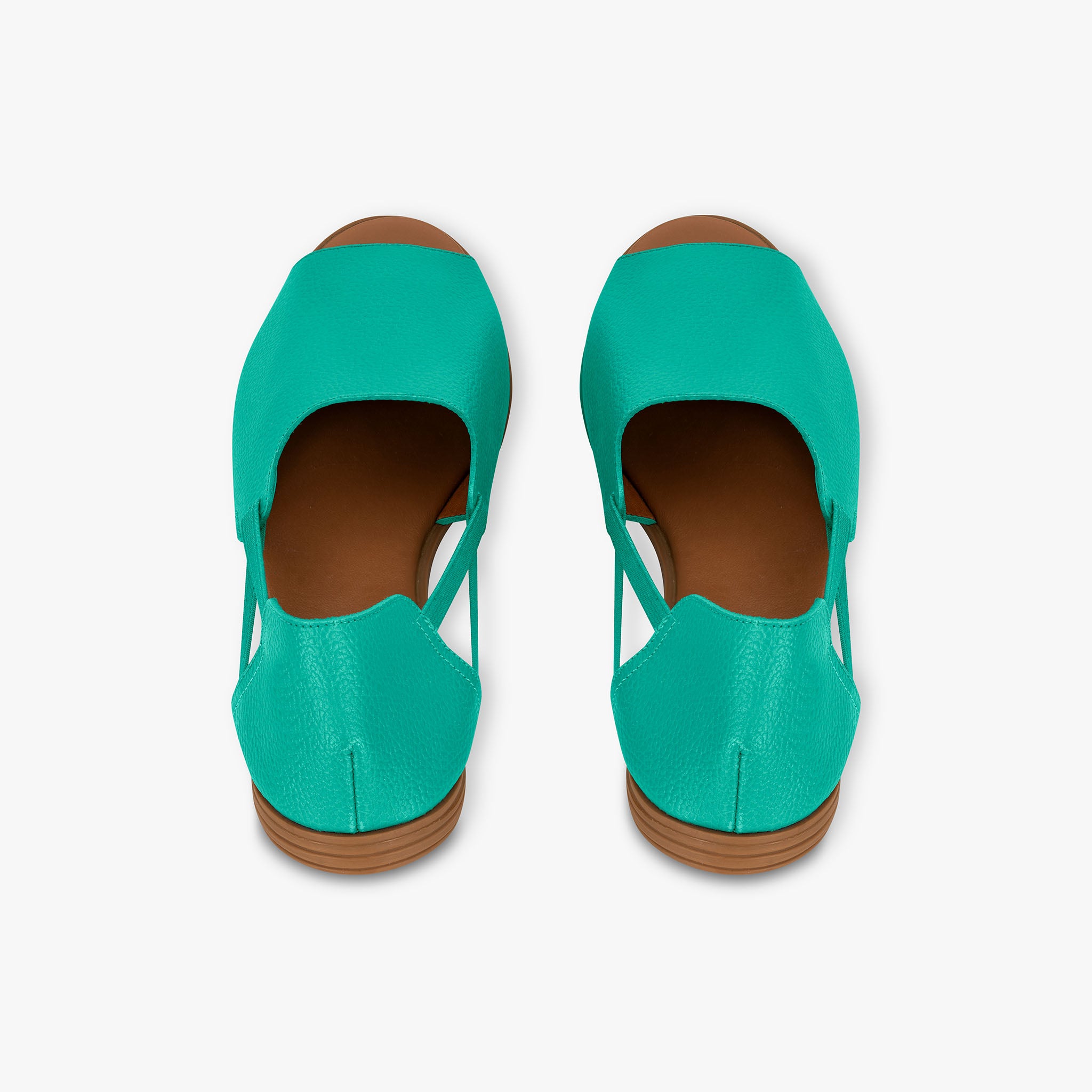 Pair of teal shoes with brown soles on a white background