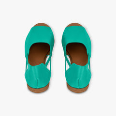Pair of teal shoes with brown soles on a white background