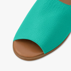 Teal sandal with brown sole on a white background