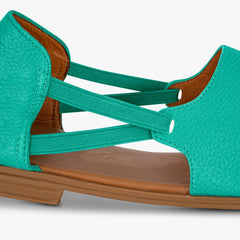 Teal sandal with brown sole on a white background