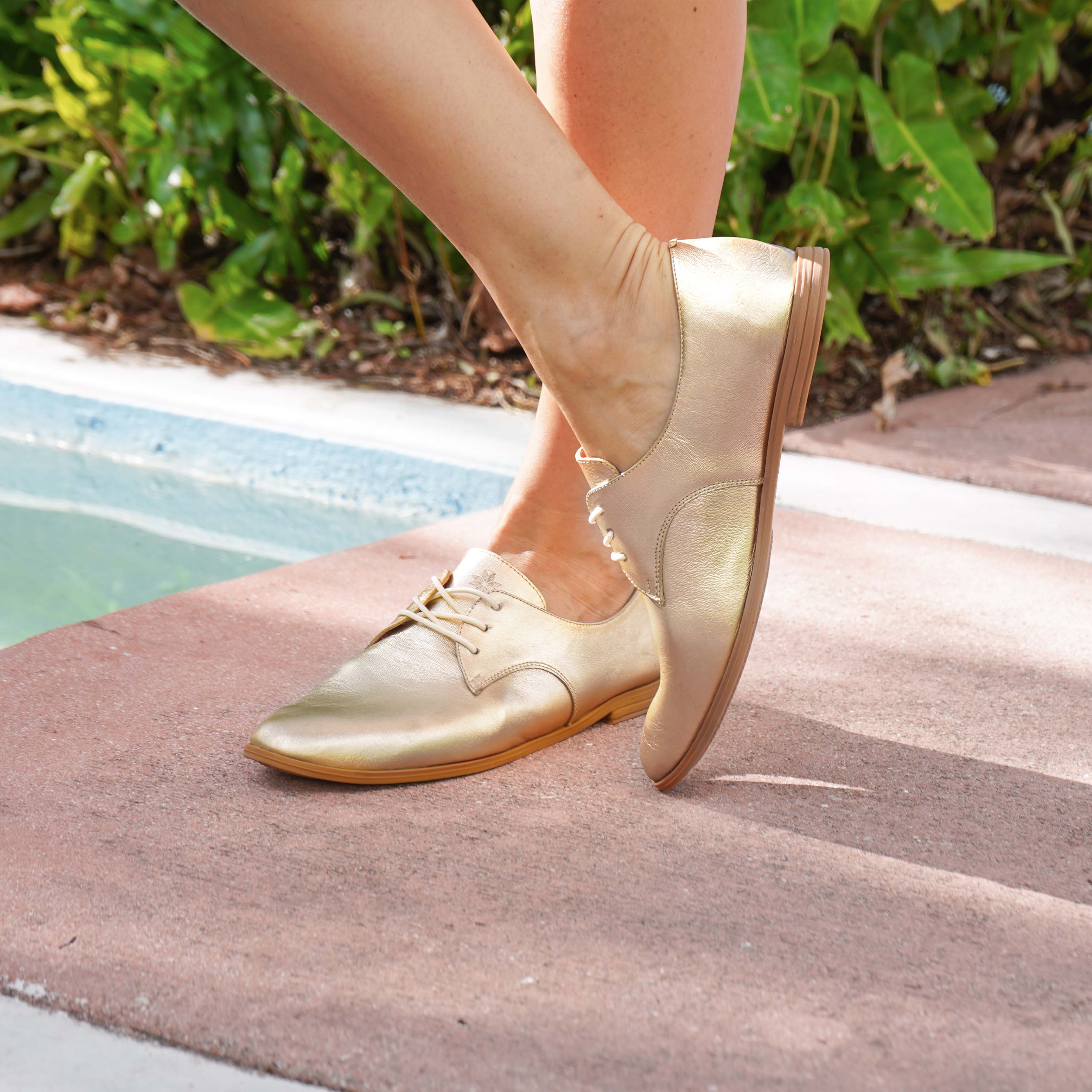 Closeup Woman wearing golden Oxford shoes