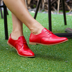 Closeup Woman sitting at restaurant with red Oxfords