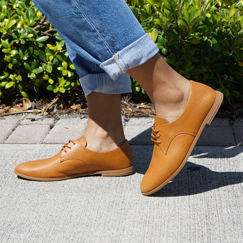 Closeup Woman wearing tan oxford shoes