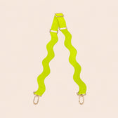 Neon green bag strap with wavy pattern on a beige background