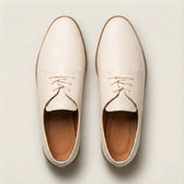 Pair of cream-colored shoes on a light background