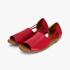 Red sandals with brown soles on a white background