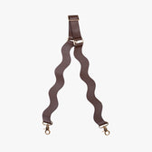 Brown bag strap with gold hardware on a white background