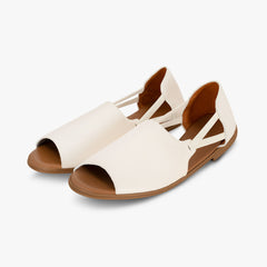 Pair of white sandals with brown soles on a light gray background