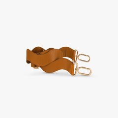 Brown leather belt with gold hardware on a white background