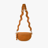 tan Crossbody bag hanging from wavy strap