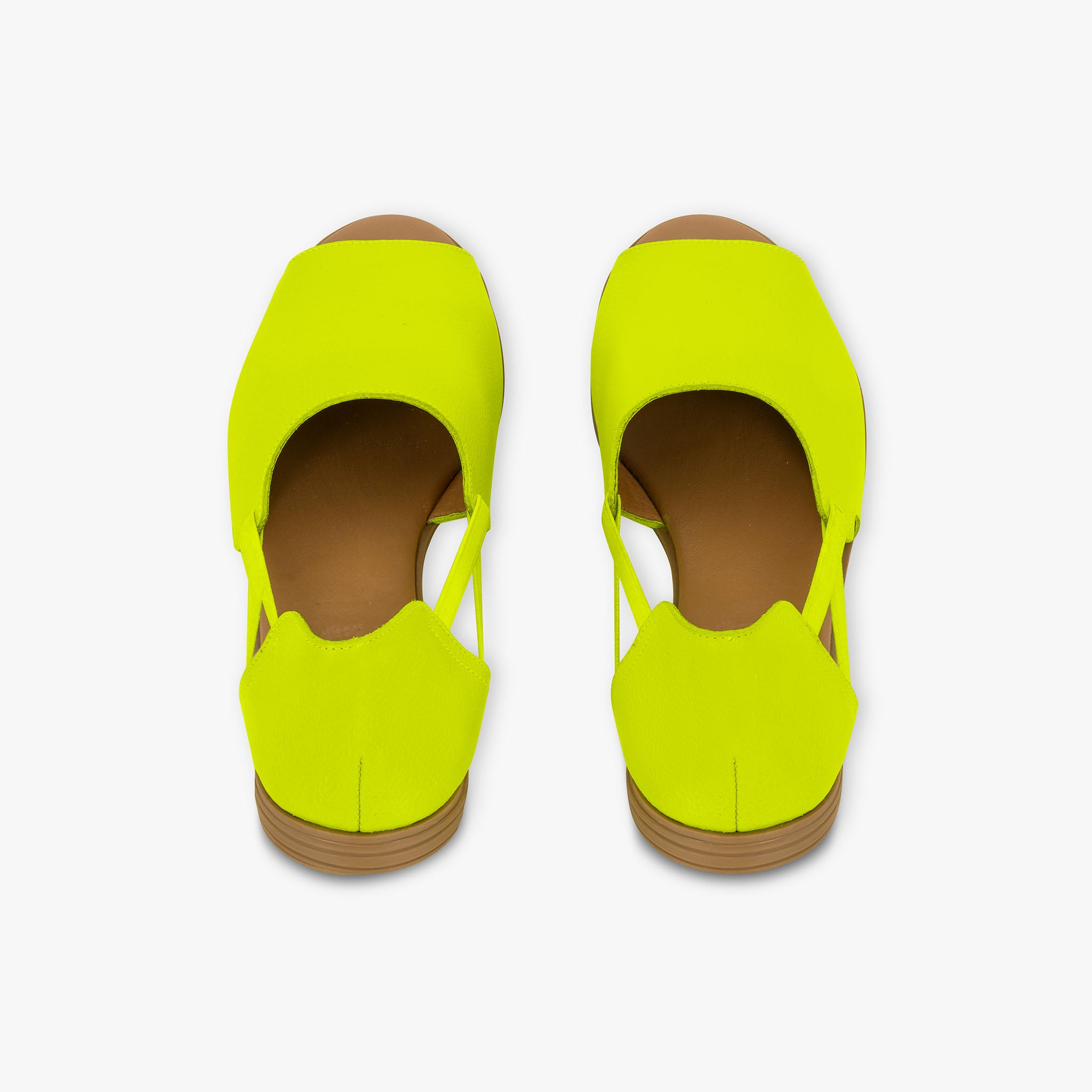 Pair of neon yellow shoes on a white background