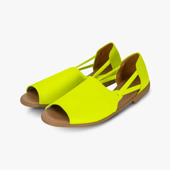 Pair of neon yellow sandals with brown soles on a white background