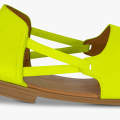 Neon yellow sandal with brown sole on a white background