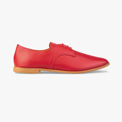 Red leather shoe with a brown sole on a white background