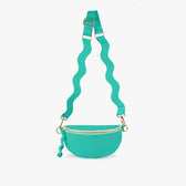 Turquoise Crossbody bag hanging from wavy strap