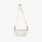 Cream Crossbody bag hanging from wavy strap