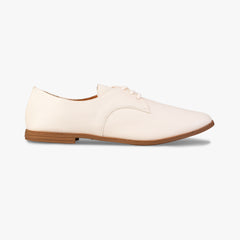 White leather shoe with brown sole on a white background