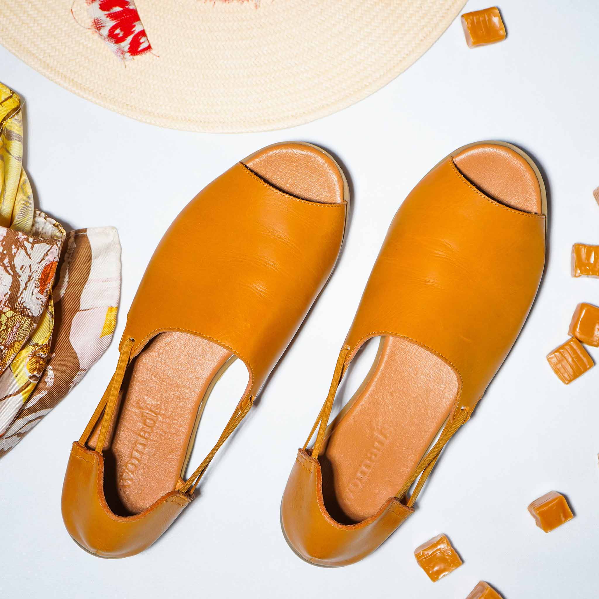 Womads tan sandals with props