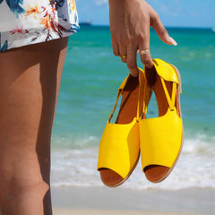 Womads yellow sandals at beach close up