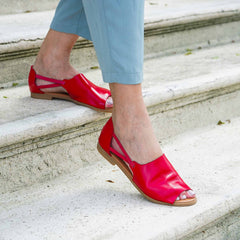 Woman walking in red sandals close up