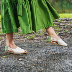 Close up of woman wearing green and cream Womads at park